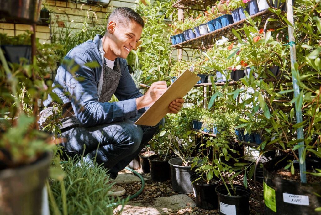 Green, plants and man with checklist, inventory check at nursery, plant store and garden business.